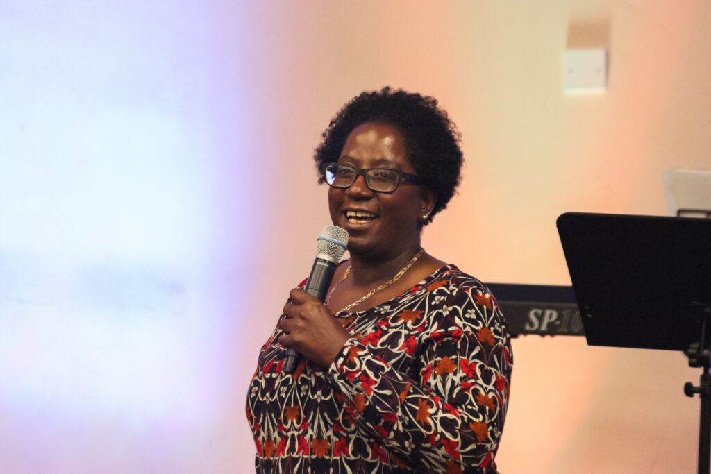 A woman speaking at the front of church