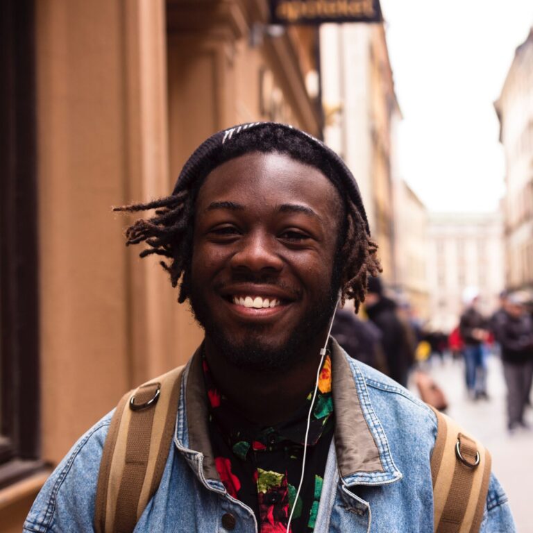 A man smiling on the street